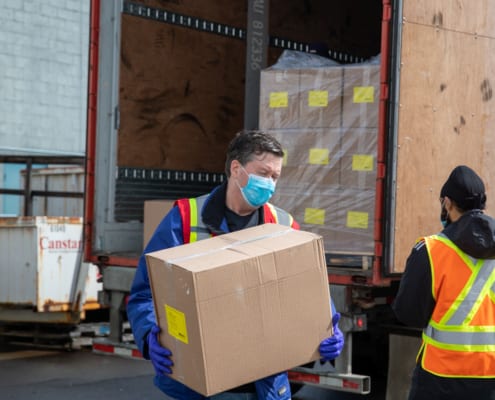 Canstar staff lifting the box near the truck at Greater Vancouver, BC
