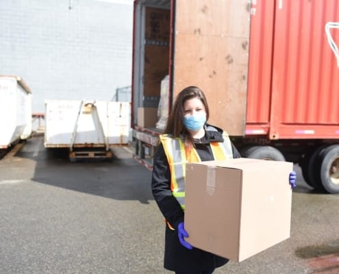 A lady holding a package box in Greater Vancouver, BC
