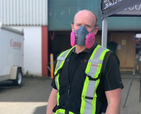Staff with corona mask and safety jacket in Greater Vancouver, BC 